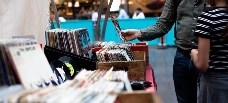 people browsing through records at a yard sale