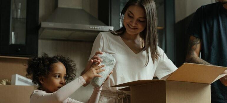 mother and daughter unpacking