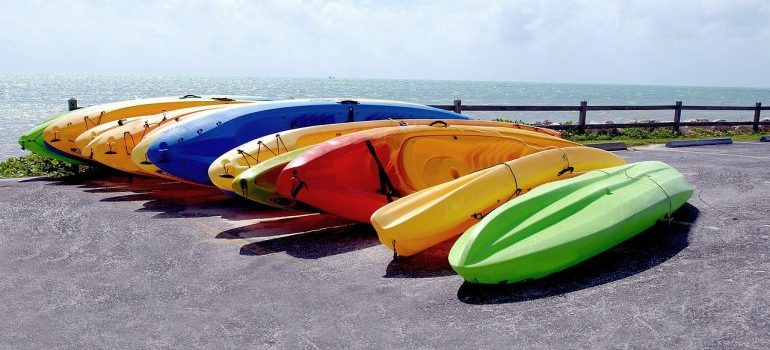 kayaks on the beach lined up next to each other