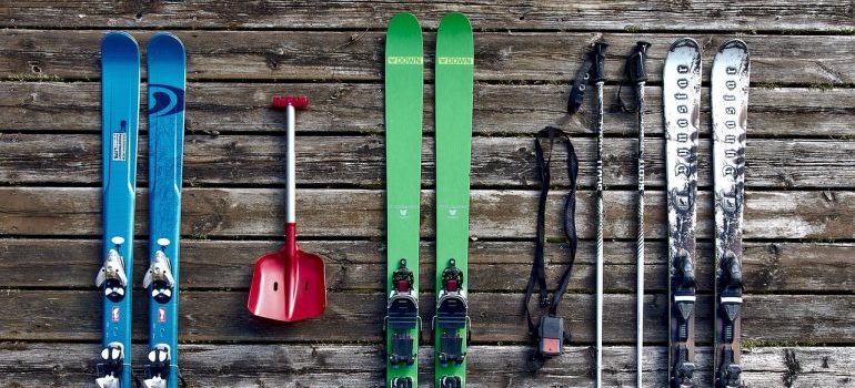skies, and rest of the ski equipment on the floor. Storing sports equipment by putting on the wall