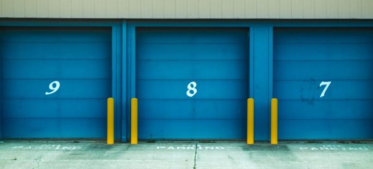 Blue door of three storage units numbered 9, 8, and 7.