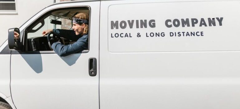 A man sitting in the white moving company van