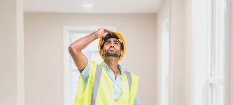 A man inspecting a house.